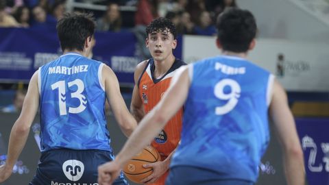 Caio Pacheco maneja la bola entre Mart�nez y Peris.