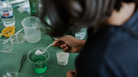 Un nio participa en uno de los experimentos divulgativos organizados por la UDC.