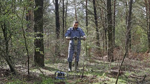 El investigador del departamento de Producci�n Vexetal de la USC haciendo una cata en el monte Carballo, en Friol.