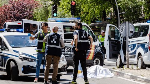 Polic�as nacionales custodian el cuerpo de una de las v�ctimas del atropello.