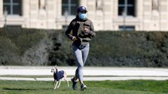 Una corredora parisina, junto a su perro, en los jardines Tuileries