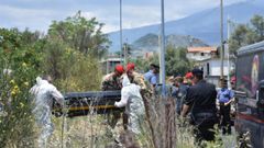 Policias forenses recoge el cuerpo de la ni�a encontrado en un descampado cerca de su casa en Catania.