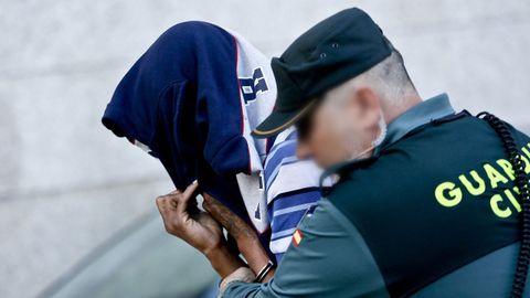 Un guardia civil acompa�a a un miembro de la banda Los Betas detenido en una imagen de archivo.