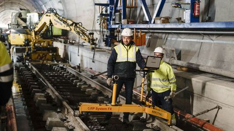  En este tramo la va tiene un ligero peralte y los operarios toman medidas para detectar cualquier desviacin. Si la hay, habra que deshacer el hormign.