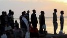 Migrantes son desalojados de la playa del Trampol�n en Ceuta.