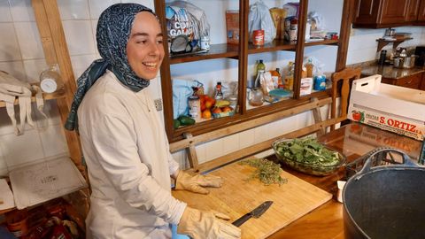 Una voluntaria procedente de Turqua prepara un caldo de ortigas en la cocina del pazo.