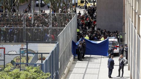Vecinos y medios de comunicacin se agolpan tras el cordn policial. 