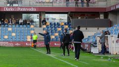 Rub�n Dom�nguez da una orden a sus jugadores al fondo de la imagen, mientras Jorge Cuesta, de espaldas, camina hacia el banquillo