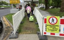 Usuarios accediendo a la parada, en Alfonso Molina, por el paso provisional con suelo de tierra. 