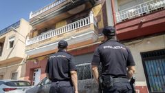 Imagen de archivo de dos agentes de la Polic�a Nacional ante una vivienda incendiada.