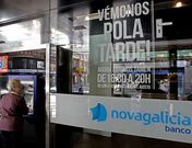 Una mujer opera en un cajero en una oficina de NCG en A Corua.