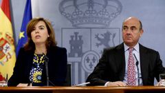 El ministro de Econom�a, Luis de Guindos, y la vicepresidenta del Gobierno, Soraya S�enz de Santamar�a, explican en rueda de prensa los acuerdos adoptados en el Consejo de Ministros