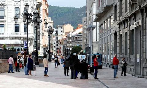 Miembros de protecci�n civil reparten mascarillas este lunes en la estaci�n de autobuses de Oviedo.