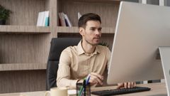 Una persona escribiendo con un ordenador.