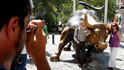 Turistas fotografi�ndose ante la escultura de un toro en Wall Street (Nueva York).