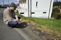 Alejandro Mascu��n, mostrando la hierba quemada en las inmediaciones de su vivienda. 