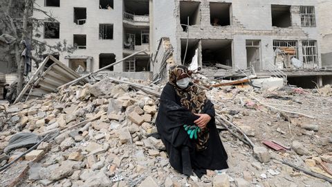 Una mujer, junto a su vivienda destruida en Teher�n.