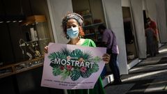 Una artesana que participa en Mostrart posa con el cartel de la 36 edici�n de la feria de A Coru�a