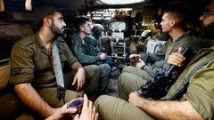 Soldados israel�es a bordo de un veh�culo blindado en direcci�n a Gaza.