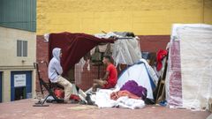 Inmigrantes se protegen de la lluvia con telas y lonas en Ceuta.
