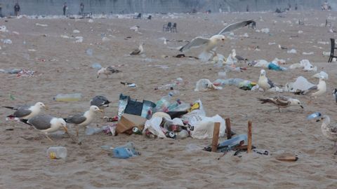 Las playas de Riazor y Orz�n amanecen llenas de basura tras la noche de San Xo�n