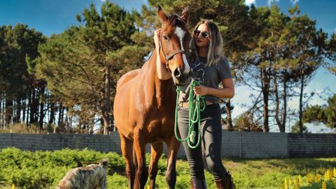 Martnez mira a cmara sujetando con una cuerda a uno de sus caballos.