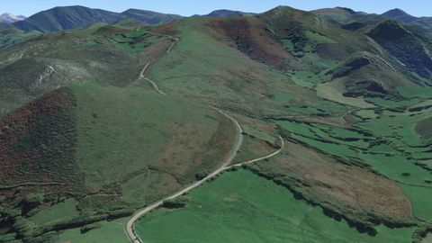 En primer plano, el pico Mirayu (Grado, Asturias), visto desde la cara sur. La carretera que lo bordea es el Camino de la Mesa. A la derecha, la vega hmeda donde habra perecido un gran contingente de caballera musulmana