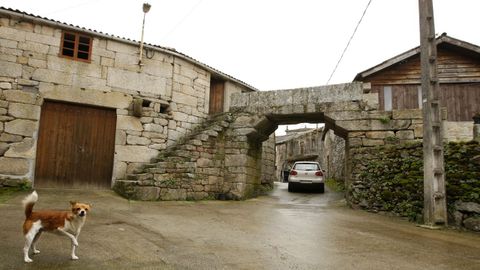 Un arco de bloques de pedra atravesa a vía principal de San Mamede