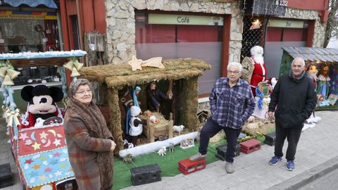 Manolo, Irene y Rafael decoran la fachada del antiguo establecimiento hostelero. 