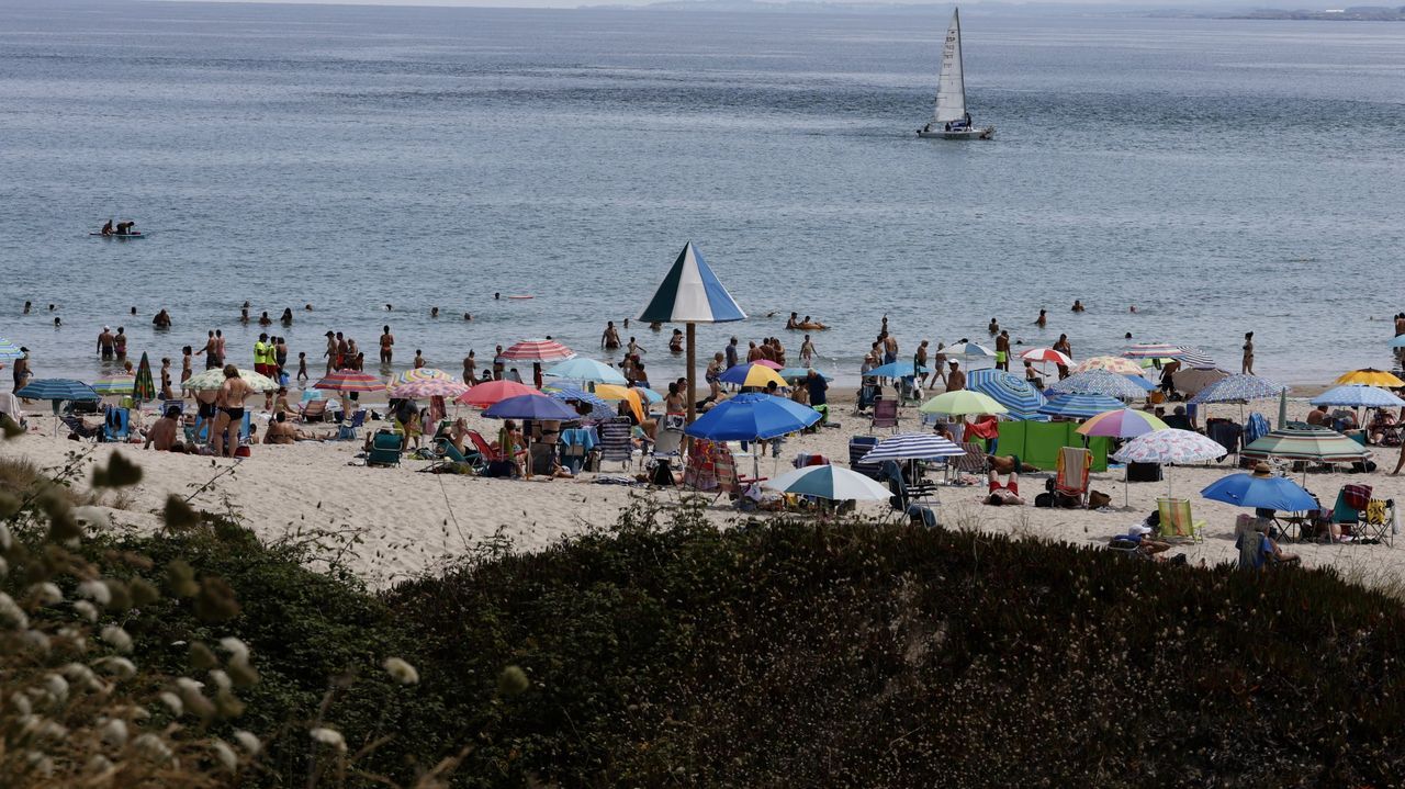 Los sanitarios atienden a una bañista en A Rapadoira, en Foz, que se desplomó saliendo del agua