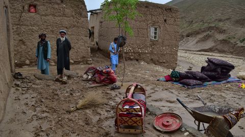 Unos afganos reunidos en una zona afectada por las inundaciones en Baghlan, Afganistn.