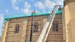 Momento en que los bomberos suben al tejado de la iglesia de San Vicente para rescatar al herido
