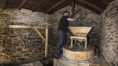 Roi Est�vez xunto � maquinaria restaurada do antigo mu��o da aldea de Vieiros