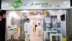 Rosi Otero bajo el cartel de la &oacute;ptica que anuncia que llevan de 1989