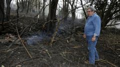 Manuel Mart�nez, en una parcela de monte calcinado con su casa al fondo