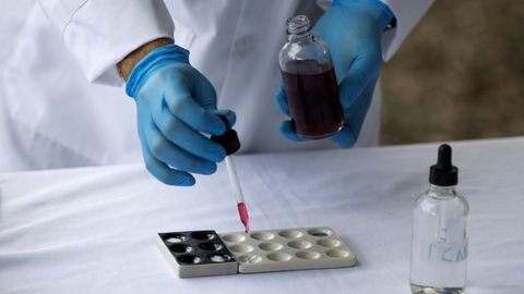 Un agente del Instituto Nacional de Ciencias Forenses de Rep&uacute;blica Dominicana analiza coca&iacute;na de un alijo incautado