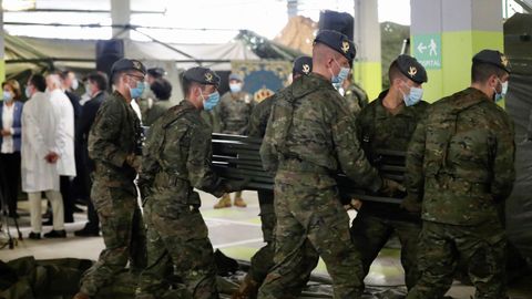 Soldados del regimiento de infanter�a n�mero 3 de la Brigada Galicia con base en Cabo Noval durante el repliegue parcial de la estaci�n de triaje instalada por el ej�rcito en uno de los aparcamientos del Hospital Universitario Central de Asturias (HUCA)