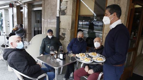 Bossa, gestor del bar de Viveiro del mismo nombre, agasajando con pinchos a sus clientes en la terraza, este s�bado