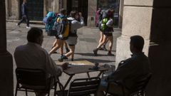 Imagen de archivo de un grupo de peregrinos pasando ante una terraza de la plaza de Cervantes, en Santiago.