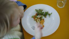 Un nio comiendo en una escuela infantil en una imagen de archivo