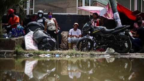 Un grupo de venezolanos desplazados tras el terremoto de La Guaira en la calle. 