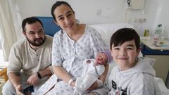 Sarela en brazos de su madre Montserrat, junto a su padre Santiago y su hermano Xin