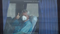 Un pasajero brit�nico del crucero MV Hondius levanta el pulgar mientras viaja en autob�s hacia el aeropuerto, en el puerto de Granadilla de Abona, en Tenerife. 