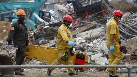 Un equipo de rescate transporta una camilla para recoger el cuerpo de una de las v�ctimas que pereci� en el colapso del edificio en obras de Bangkok.