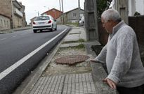 Augusto Castro tiene los agujeros sin tapar del saneamiento delante de su casa en Quilmas. 