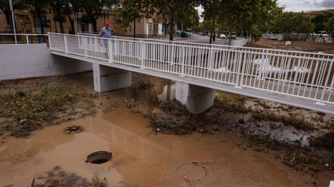 Varias personas pasan por un puente del barranco de La Saleta, en Aldaia (Valencia)