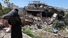 Una mujer ante los escombros de una casa en un pueblo del sur de L�bano