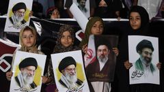 Un grupo de ni�as pakistan�es sostienen fotos de Al� Jamen�i y de su hijo Mojtaba, nuevo l�der supremo