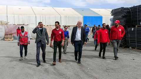 El presidente de la Subcomisión de Derechos Humanos del Parlamento Europeo, Udo Bullmann, pasea con empleados de la Media Luna Roja egipcia durante su visita a los almacenes donde se guarda la ayuda antes de ser enviada a Gaza, en medio del actual conflicto entre Israel y el grupo islamista palestino Hamás, en Al-Arish (Egipto).