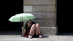 Una turista se protege del sol en el Obradoiro